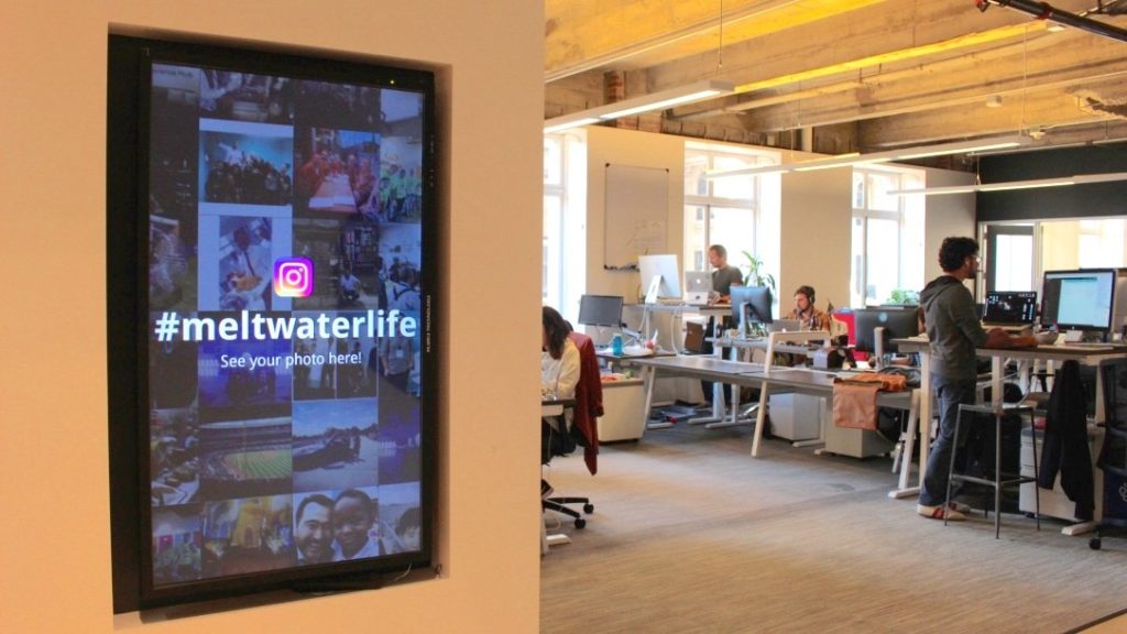An Enplug digital screen welcomes employees at Meltwater's HQ.